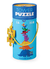Tower Puzzel Dino in een blauwe opbergkoker met kleurrijke dinosaurussen en een geel touwhandvat.
